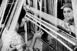 Silk weavers working together in a textile factory.