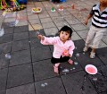 cute kids playing with bubble wands in Bukittinggi